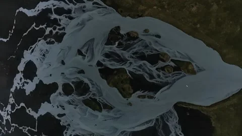 Swan Flies Over Abstract Glacial River Channels Iceland Aerial Overhead Drone Stock Footage 339622080