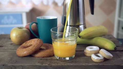 Swapping a coffee mug for a glass and serving orange juice Stock Footage 102107766