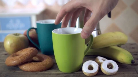 Swapping a coffee mug for a glass and spilling orange juice Stock Footage 102108408