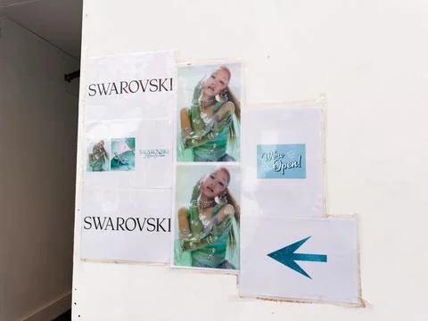 Swarovski store poster display with model images and open sign directing cu.. Stock Photos