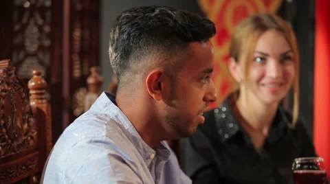 Swarthy guy talk with woman in restaurant Stock Footage