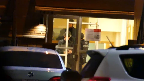 SWAT chatting on cellphone Stock Footage 120000595