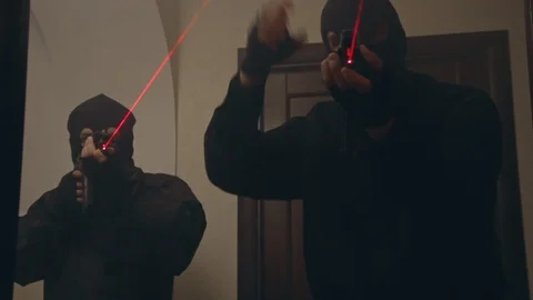 SWAT in masks with automatic guns with laser sights enters the house Stock Footage 103122761