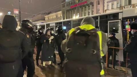 SWAT officers cops take the detained women to prison truck. Anti war protests Stock Footage 170976065