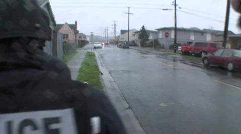 A SWAT team of DEA agents conduct a raid on a crack house. Stock Footage