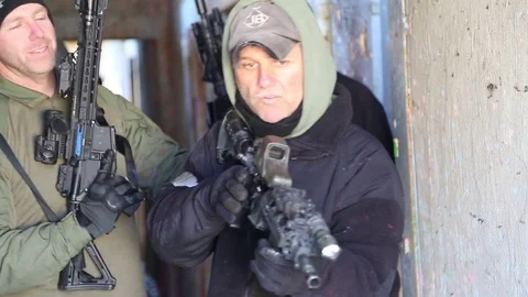SWAT Trainee Stands Ready in Open Doorway Stock Footage 70561416