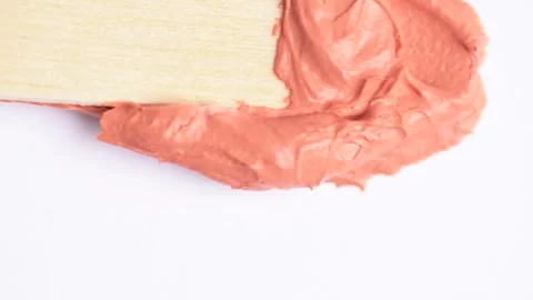 Swatch of clay mask. Stroking orange clay mask over white surface. Texture .. Stock Footage 271129731