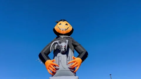 Swaying Inflatable Pumpkin Head and Gargoyle Halloween Display Stock Footage 348317792