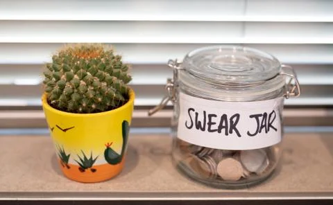 Swear jar positioned on the kitchen window sill Stock Photos