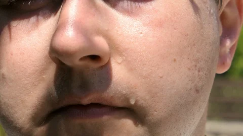Sweat runs down a man's face, wipes away sweat Stock Footage 115576746