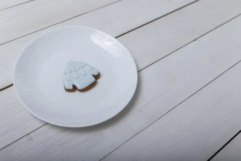 Sweater shape gingerbread cookie on white plate standing on white table Stock Photos