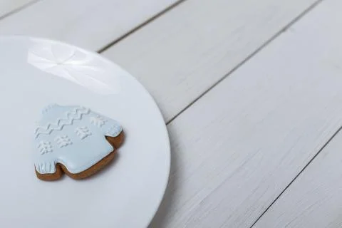 Sweater shape gingerbread cookie on white plate standing on white table Stock Photos