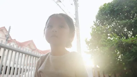 Sweating kid playing jumping workout at home garden on sunny day Stock Footage 188469728