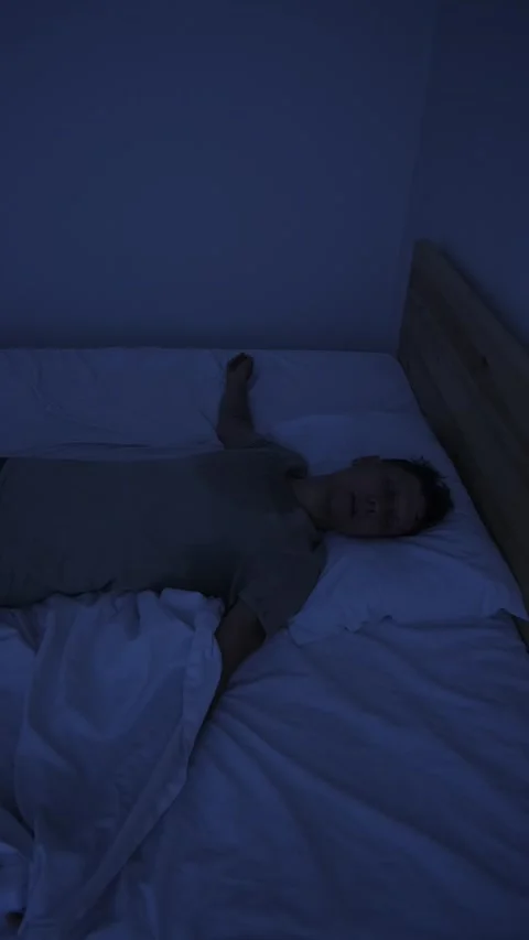 Sweating man suffering from night sweats and extreme heat, tossing in bed and Stock Footage 346248892