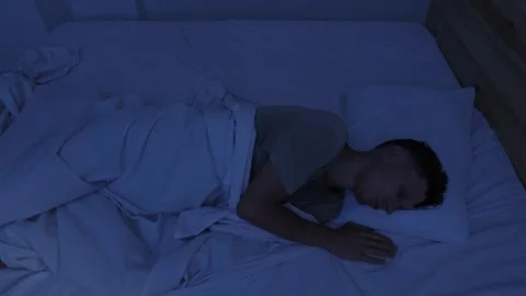 Sweating man suffering from night sweats and extreme heat, tossing in bed and Stock Footage 346249407
