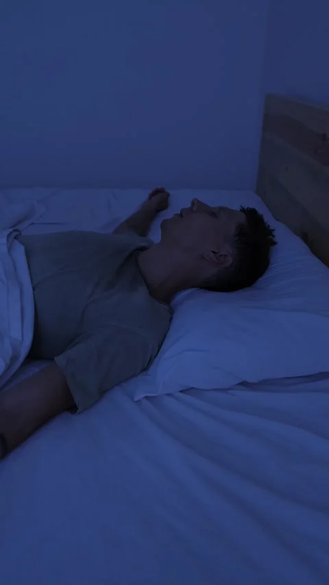 Sweating man suffering from night sweats and extreme heat, tossing in bed and Stock Footage 346249869