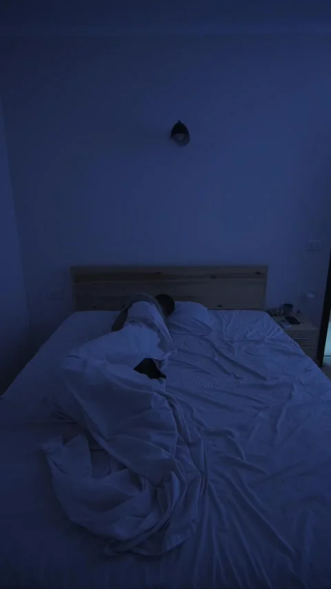 Sweating man suffering from night sweats and extreme heat, tossing in bed and Stock Footage 346250655