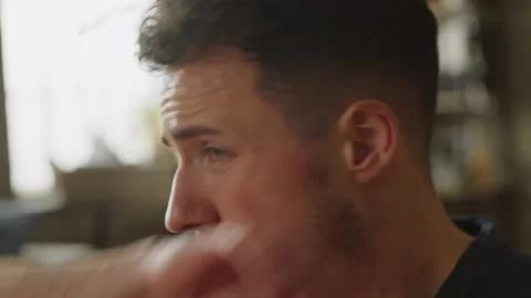 Sweating muscular athletic man in gray outfit poses after workout at home in his Stock Footage 169015188