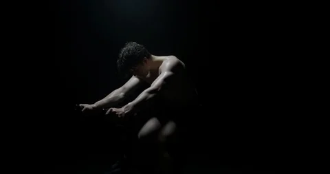 Sweaty Man Exercising On Exercise Bike Shirtless Training As Smoke Falls On Him Stock Footage 113842064