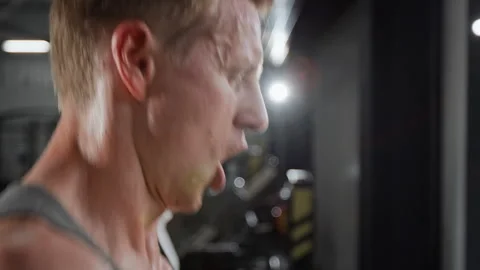 Sweaty Man Running on Treadmill during Intense Cardio Workout in Gym Stock Footage 339907381