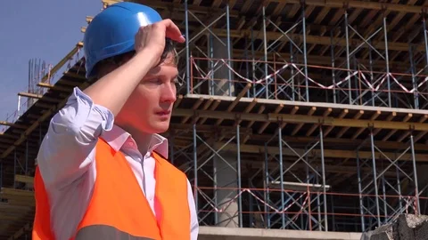 Sweaty overworked construction worker handyman taking off helmet wipe sweat look Stock Footage 82493538
