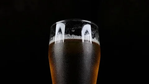 Sweaty Pint With Craft Beer Rotates on Black Isolated Background Stock Footage 78626341
