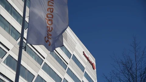 Swedbank flag and logo at headquarters in Stockholm, Sweden Stock Footage
