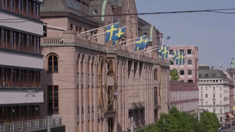 Sweden flags sticking out on side of building. Stockholm, Sweden Видео 342515334