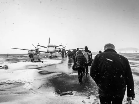 Sweden, Kalmar, Kalmar Airport, Passengers boarding small airplane in winter Stock Photos