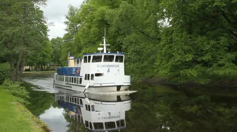 Swedish ferry boat motors down a canal Stock Footage