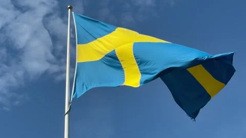 Swedish flag waving in slow motion against blue sky. Stock Footage 342490572