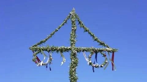 Swedish midsummer pole in Sweden. Decorated with greenery and flags waving wind Stock Footage 199300567