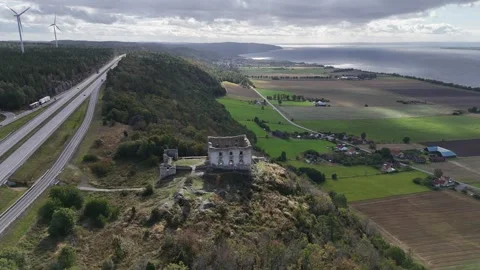 Swedish Rural Road, Fields, Wind Turbines, and Historic Stone Ruin Video stock 347673261