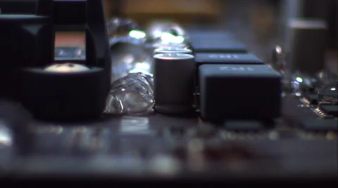 Sweep across a computer's motherboard as it fills with liquid. Slow motion. Stock Footage 64876281