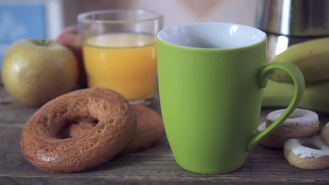 Sweep panorama of a healthy breakfast with fruit, orange juice and ceramic mugs Stock Footage 102110819