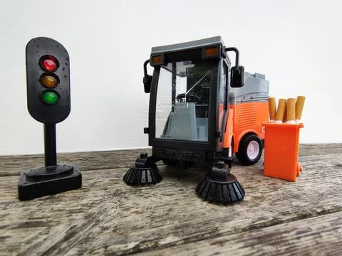 Sweeper and container with cigarettes on a white background Stock Photos