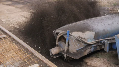 Sweeper machine clearing dirt and debris at construction site Stock Footage 310950487
