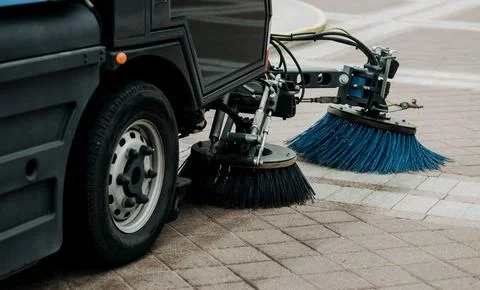 Sweeper is sweeping the asphalt. Photos