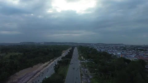 Sweeping aerial glimpse of an active highway traversing a verdant landscape.. Video stock 339037291