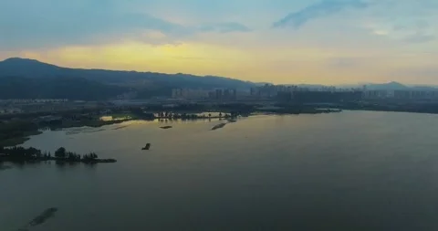 Sweeping Aerial Panorama Over Large Lake During Colorful Dusk and Sunset Stock-Footage 341908754