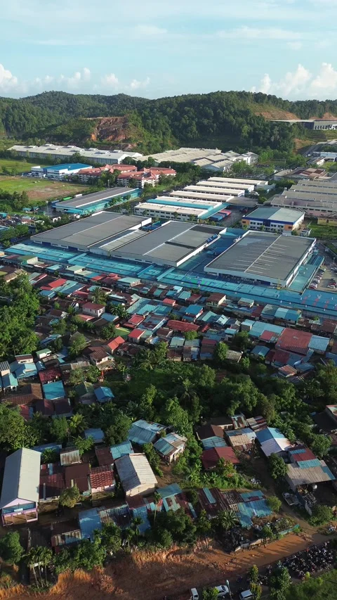 Sweeping aerial perspective of a bustling manufacturing hub bordered by res.. Stock Footage 337284514