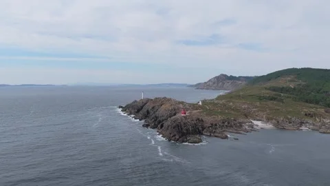 A sweeping aerial shot captures the dramatic rocky coastline of Cangas, Spain Stock Footage 346700417