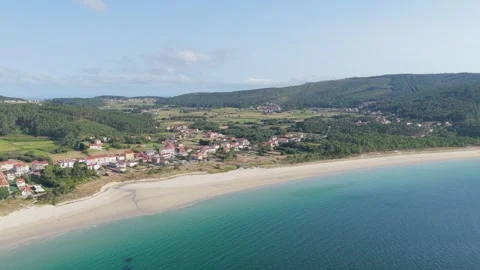 A sweeping aerial shot captures the expansive Praia Da Langosteira beach along Stock Footage 346707963