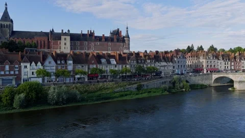 A sweeping aerial shot captures the iconic stone bridge spanning the Loire River Stock Footage 346719846