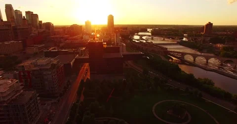 Sweeping aerial shot of Minneapolis at sunset Stock Footage