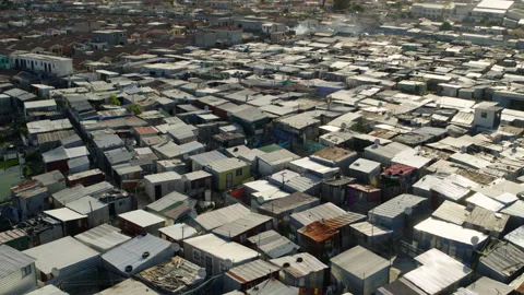 Sweeping aerial shot of poor, overcrowded african township in 4K Stock Footage 194944828