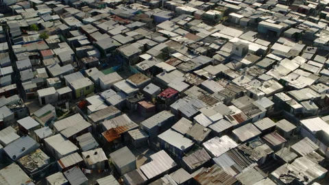 Sweeping aerial shot of poor, overcrowded african township in 4K Stock Footage 194945694