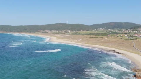 A sweeping aerial view of Praia de Traba, a long sandy beach on the Atlantic Stock Footage 346704806