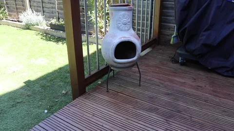Sweeping up around Chiminea Video stock 131320782