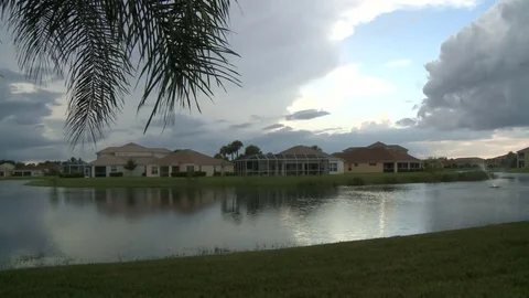 Sweeping clouds over homes Stock Footage 74096854